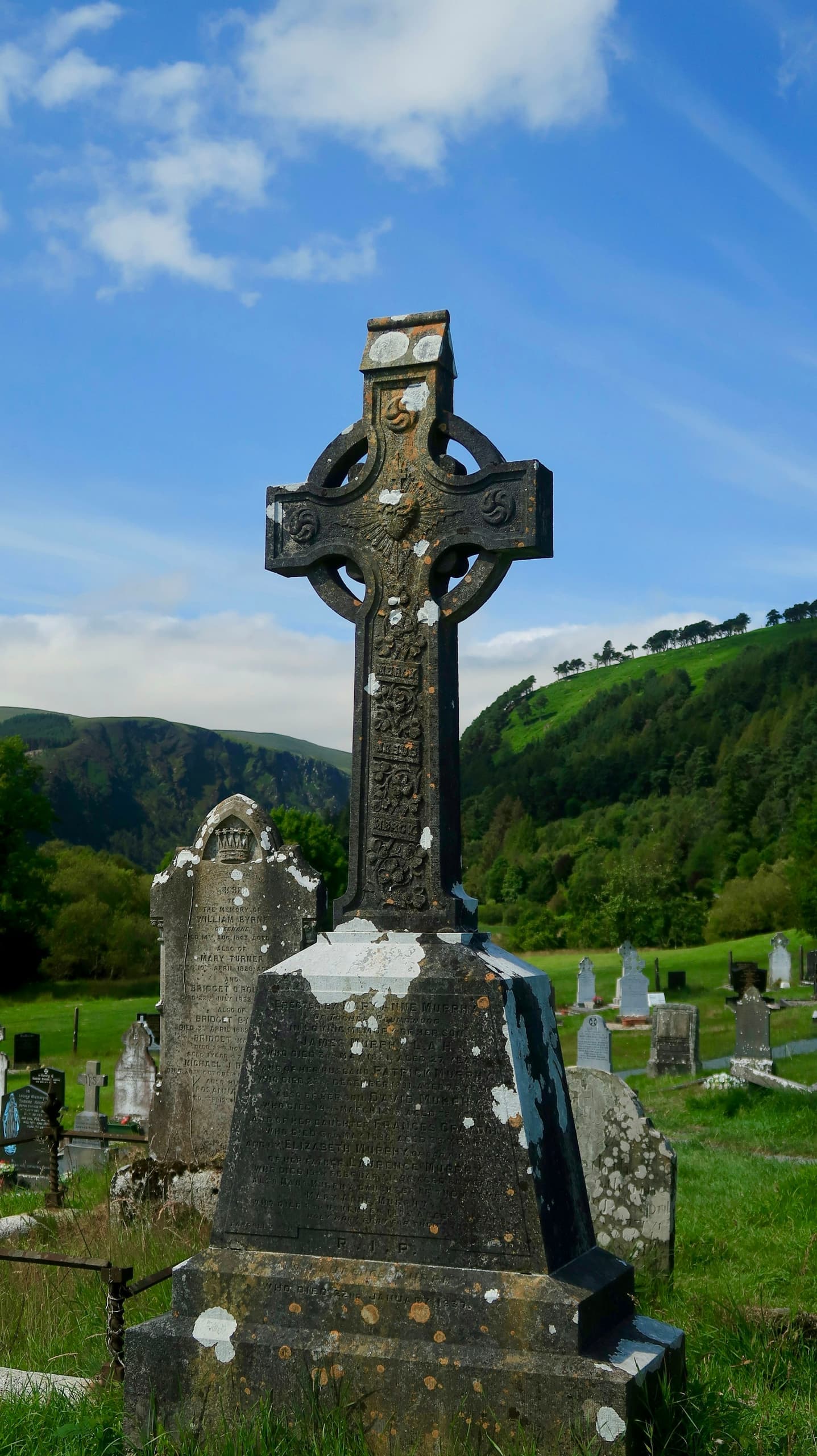 Carved stone ringed cross on a green hillside
