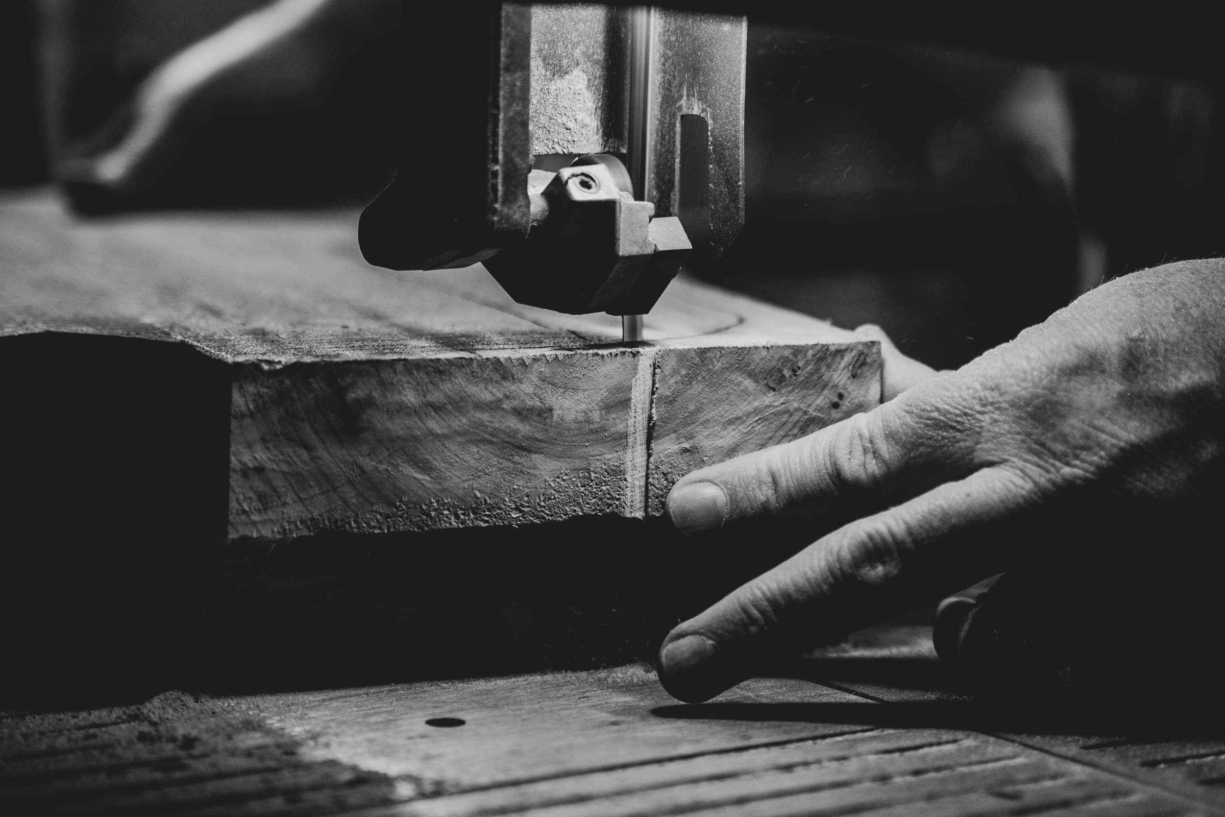 Craftsman guiding a granite slab through a precision saw
