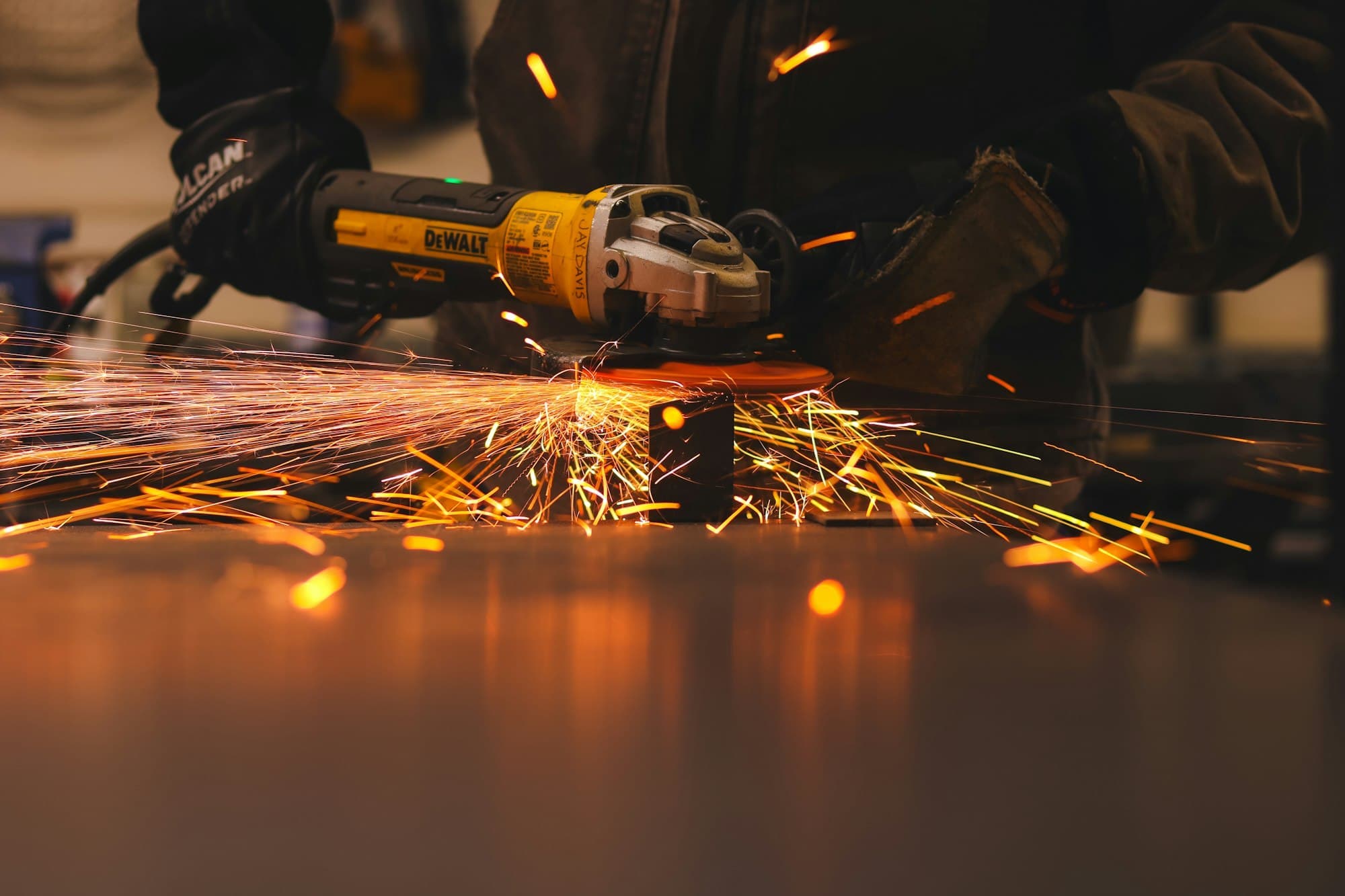 Sparks flying as a technician grinds a workpiece