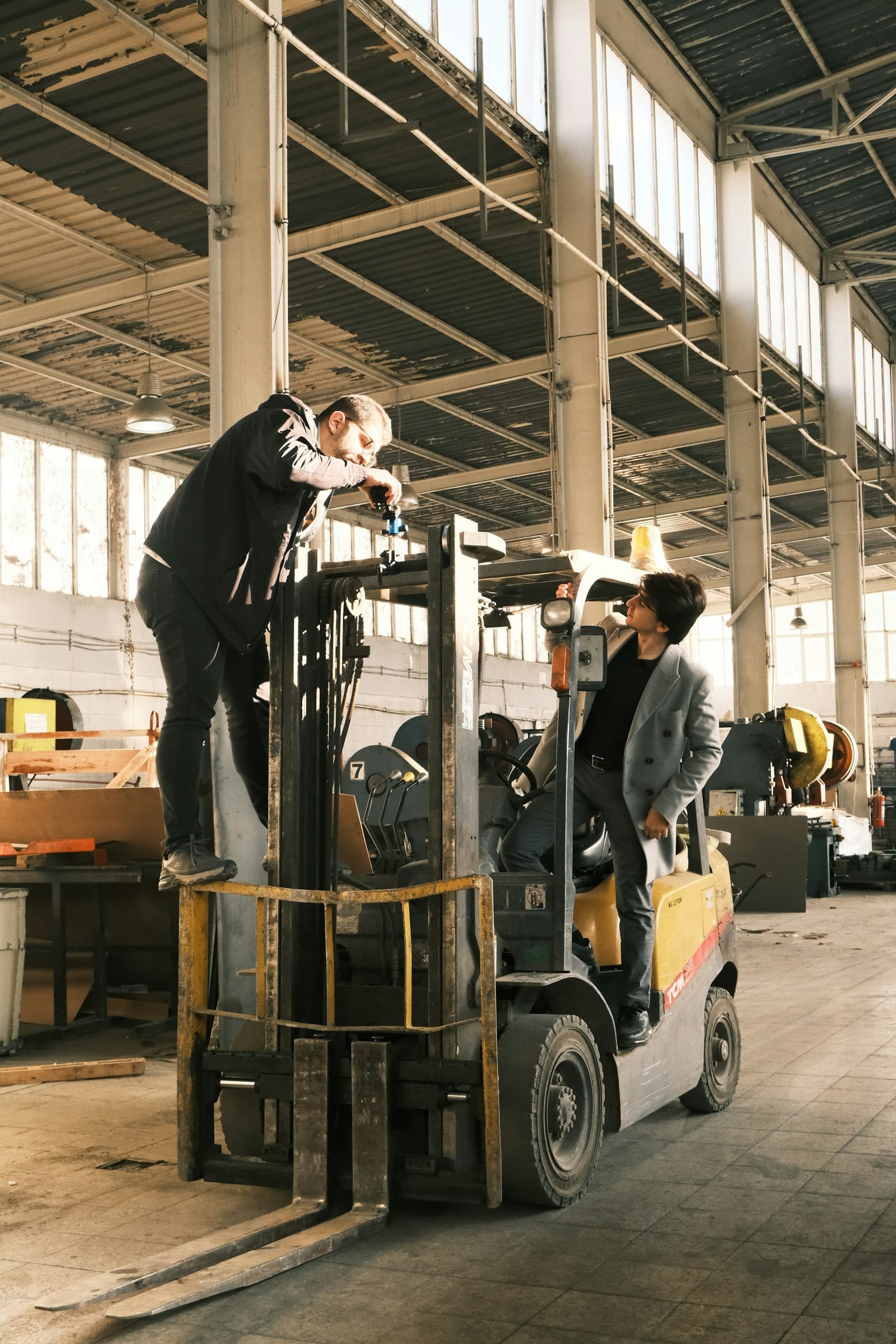 Crew working with lifting equipment inside a warehouse