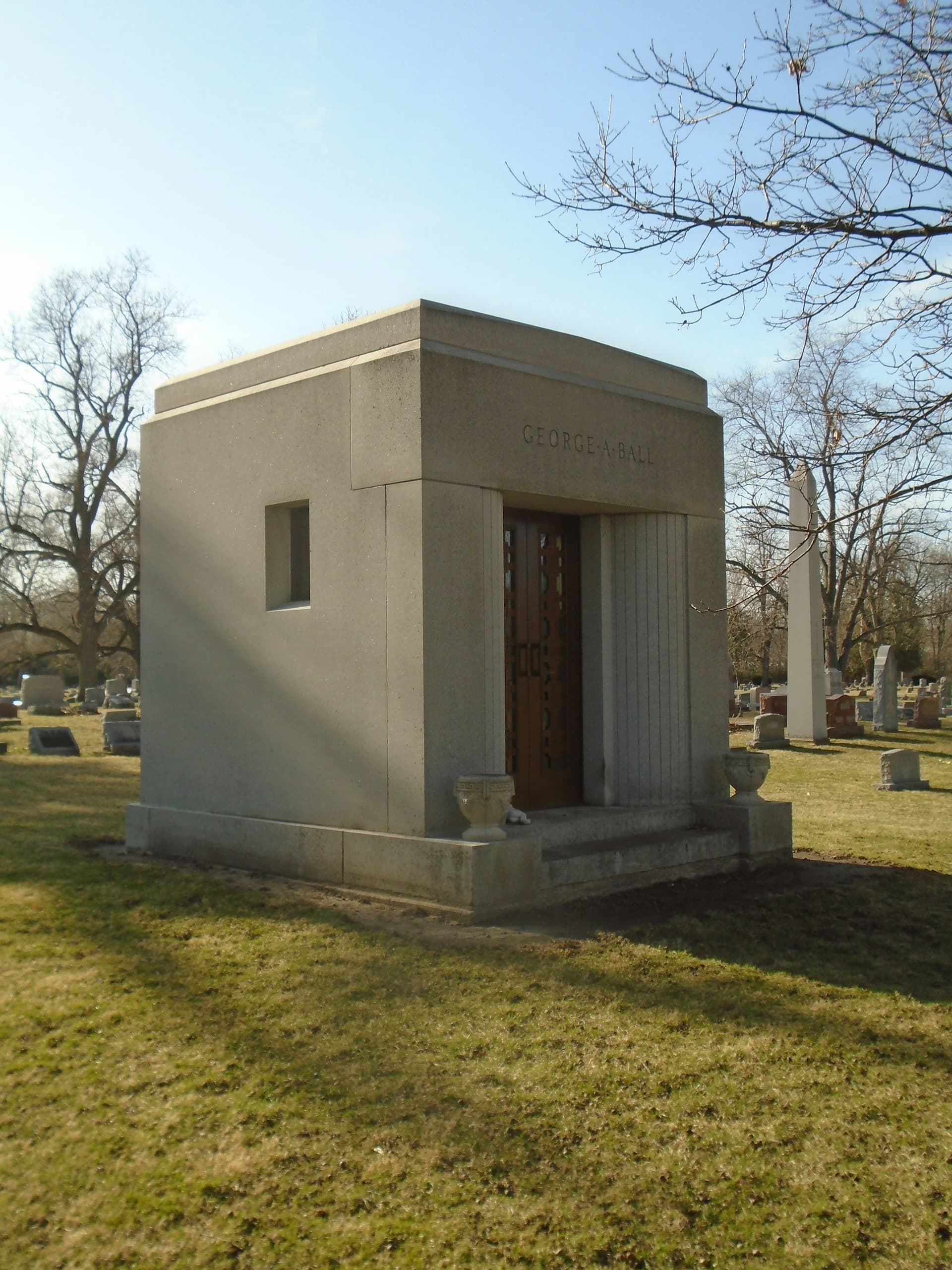 Granite family mausoleum with bronze door in a quiet cemetery