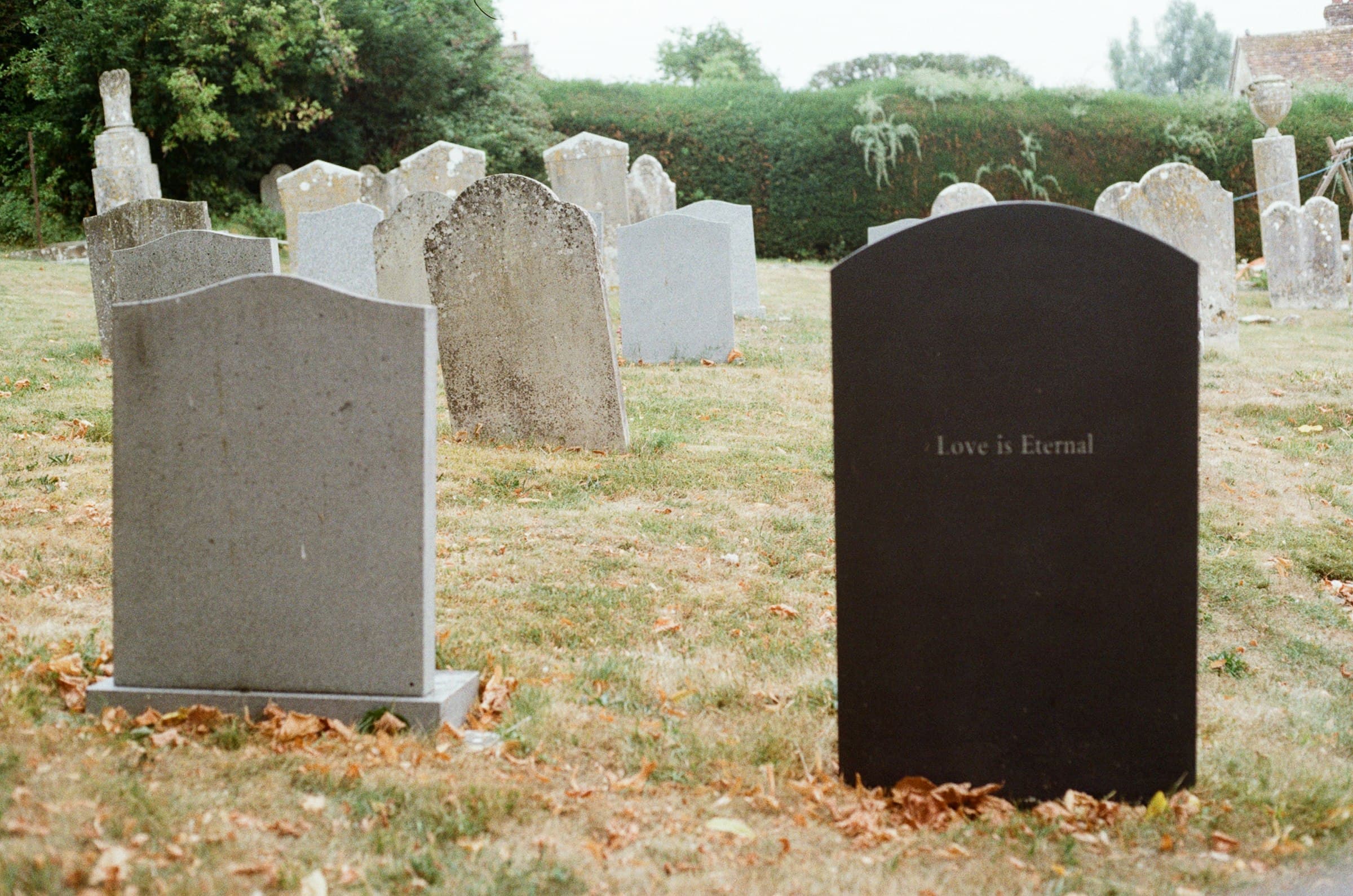 Black and gray granite upright monuments in a churchyard
