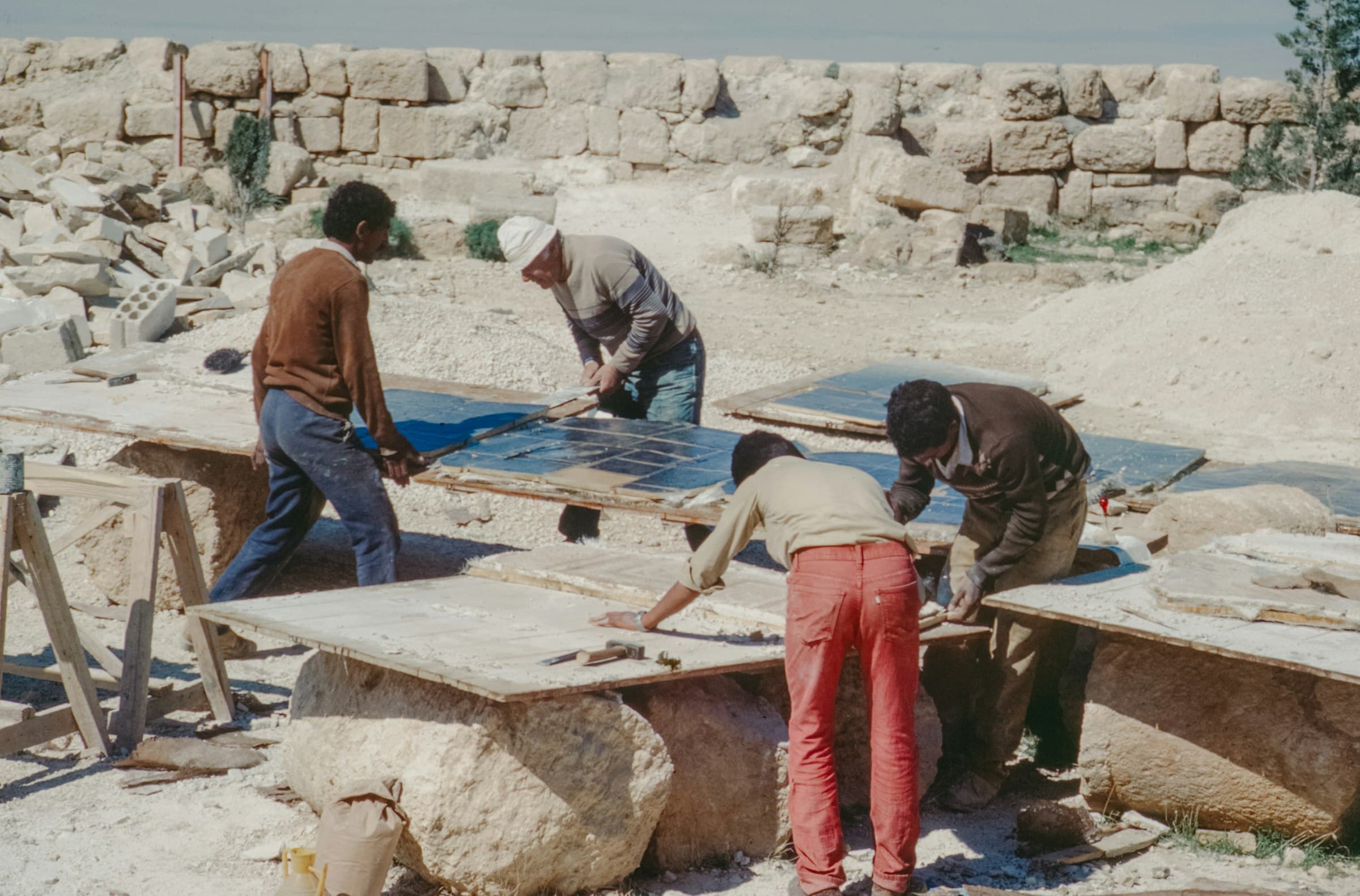 Crew finishing large granite slabs outdoors