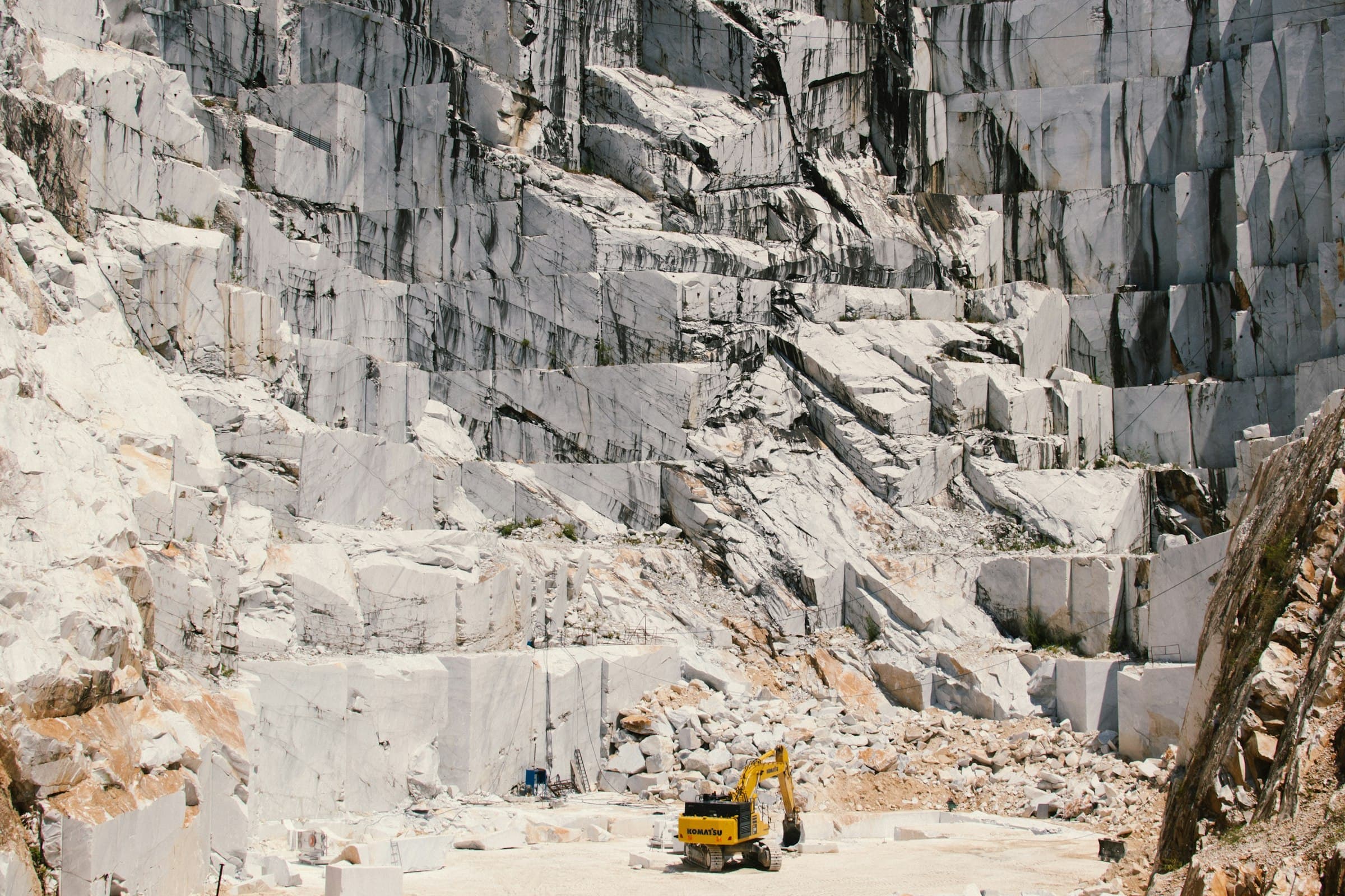 Wide view of a granite quarry with a loader